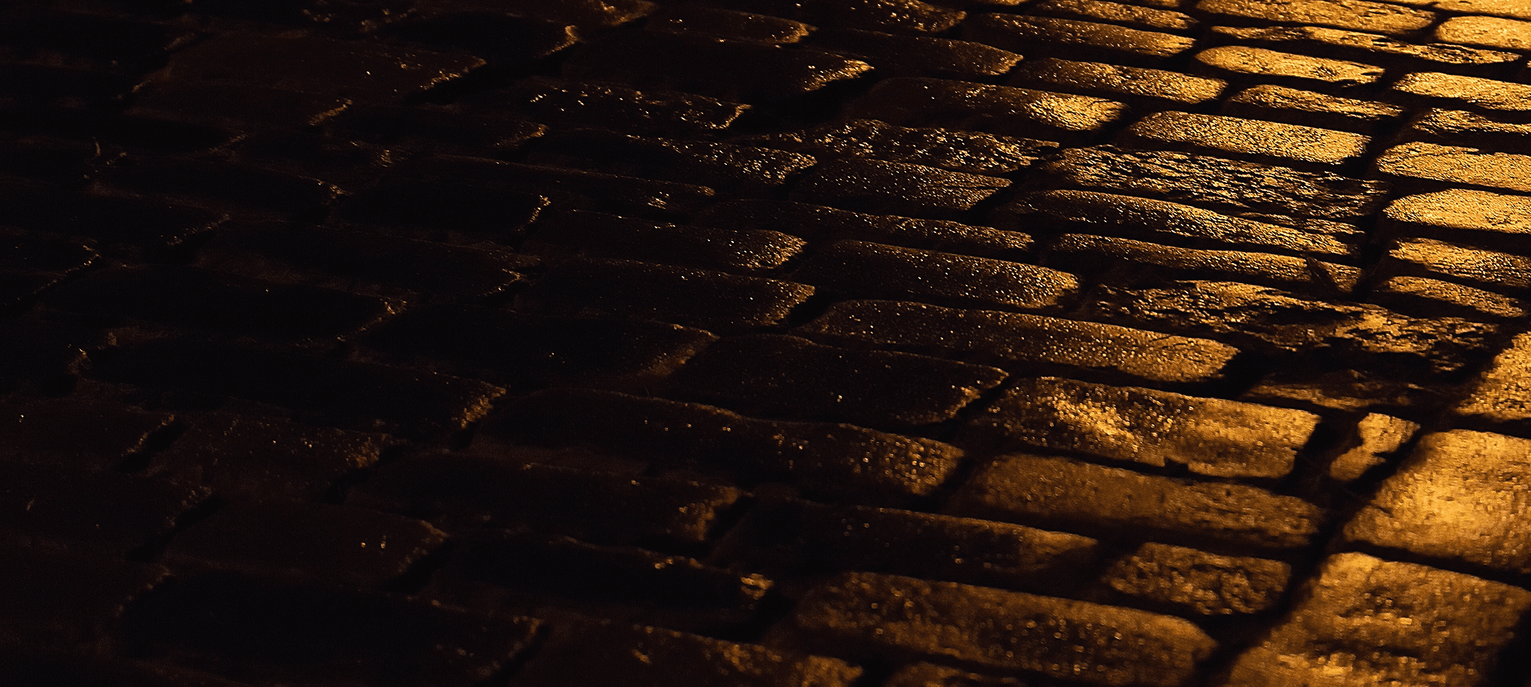 A brick road with a golden light reflecting off it
